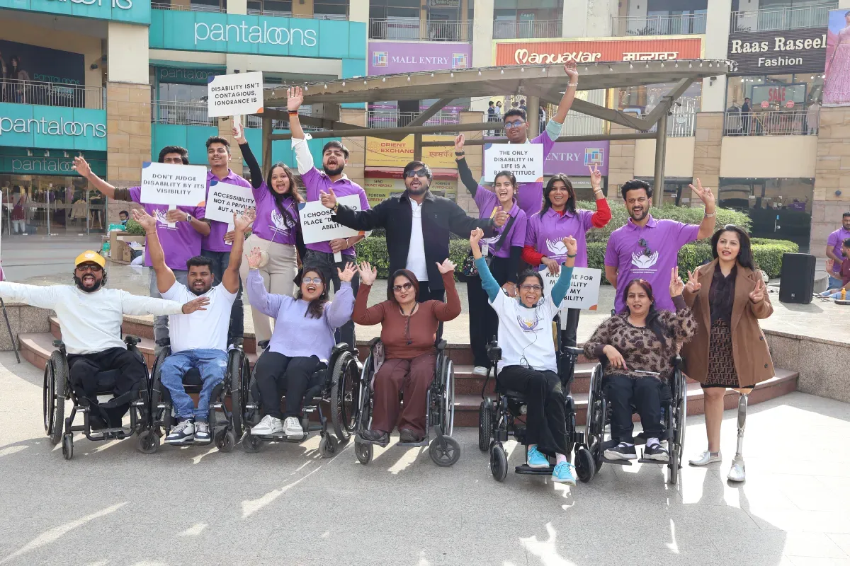 Volunteers and wheelchair users rallying together outdoors