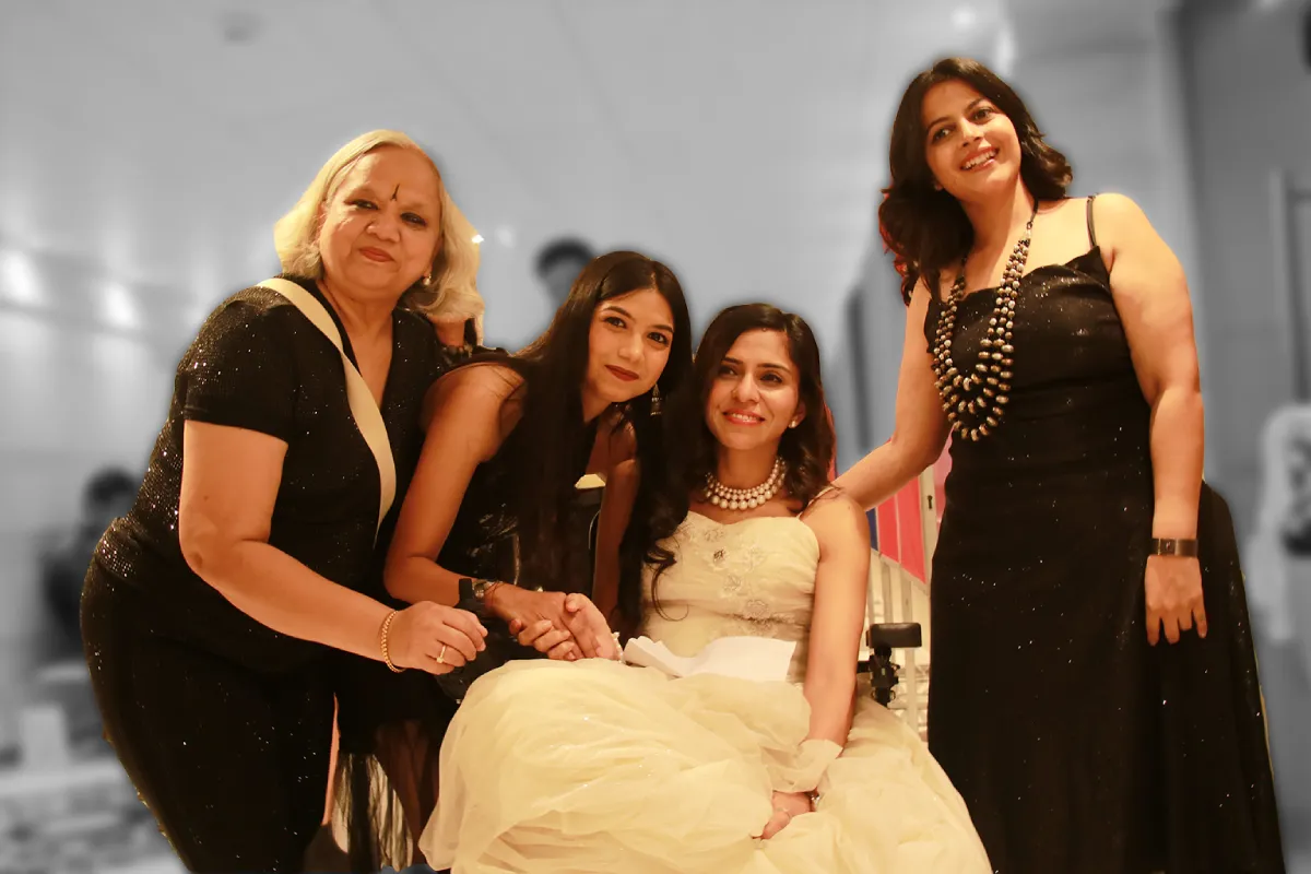 Four women smiling together at an event