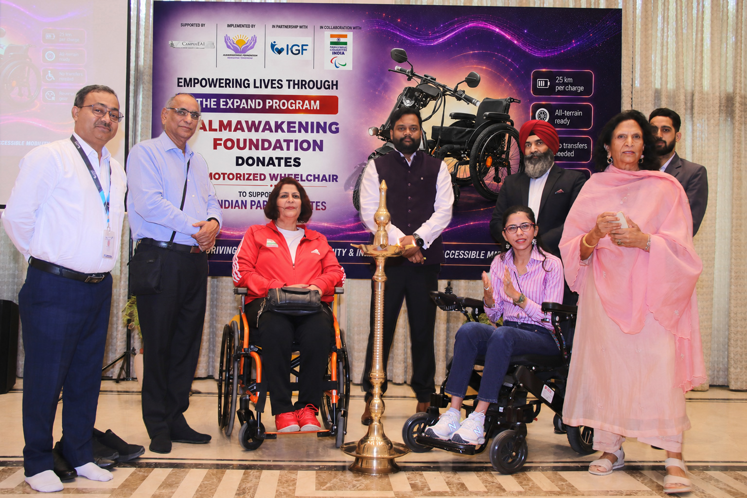 A speaker in a wheelchair addressing a hall of students